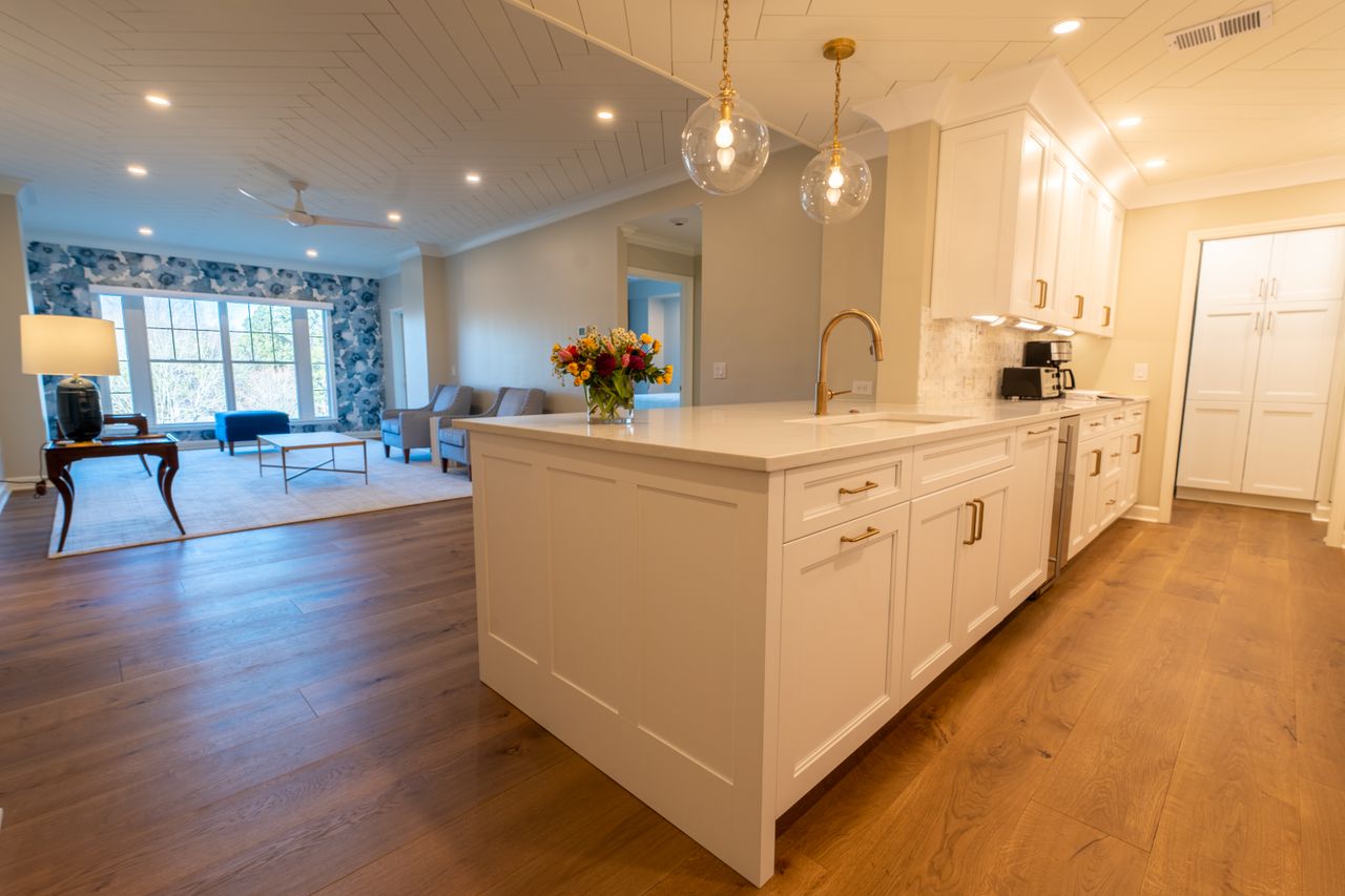 Elegant modern home interior featuring a bright, spacious kitchen with hardwood floors and stylish decor.